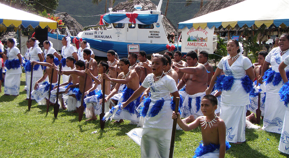 People dressed in blue and white at a Samoan ceremony