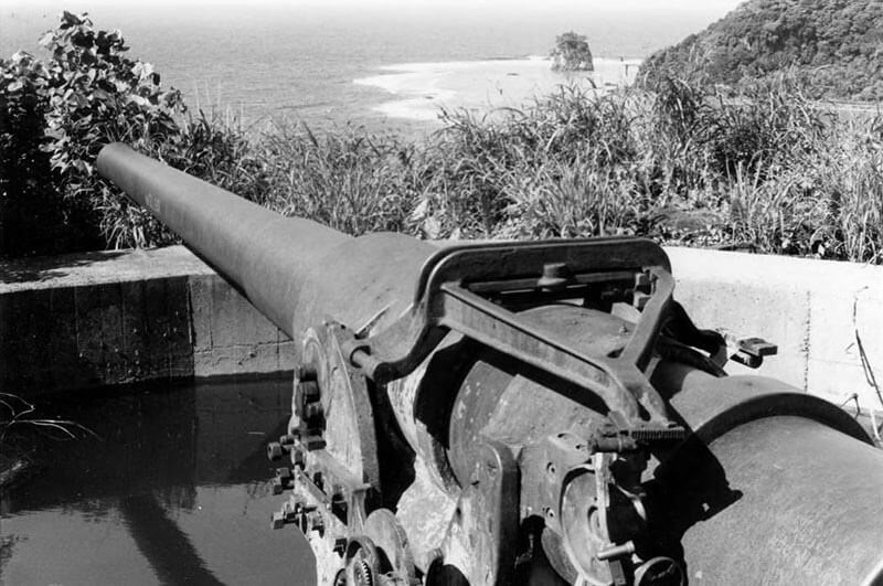 A cannon aimed out towards the ocean