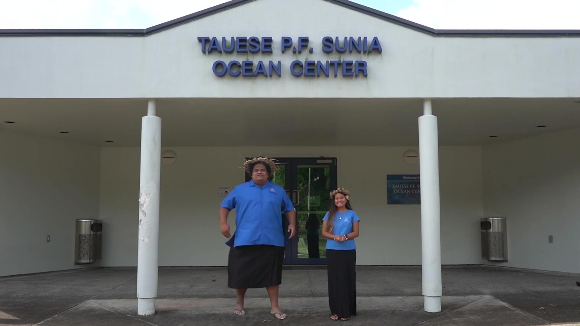 Two People Standing in front of Tauese P.F. Sunia Ocean Center